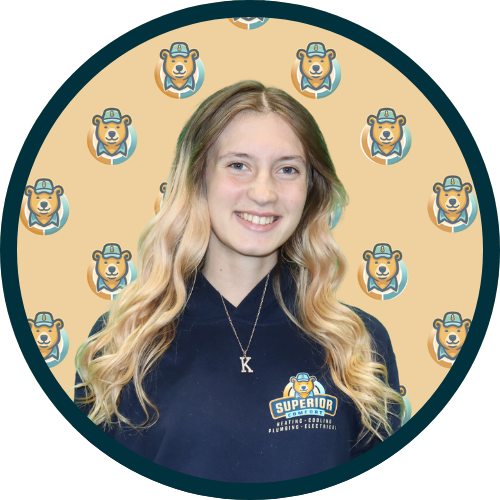 Smiling woman in a navy polo with a Superior logo, circular frame with a beige background and repeating dog mascot icons.